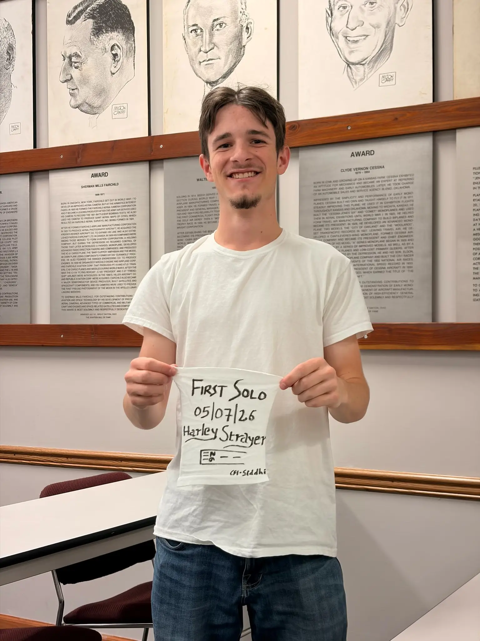 Student pilot holding a first solo shirt after soloing at Moraine Airpark in Dayton Ohio